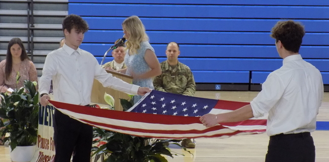 Boys preparing to fold the American Flag